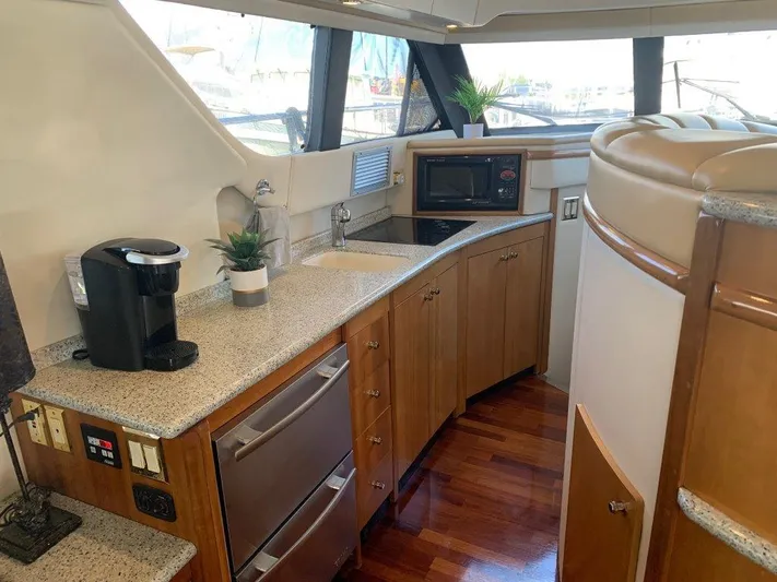  Yacht Photos Pics 2002 Carver 450 Voyager Pilothouse kitchen with modern appliances and wood cabinetry.