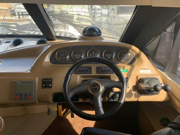  Yacht Photos Pics 2002 Carver 450 Voyager Pilothouse helm with steering wheel and instrument panel.