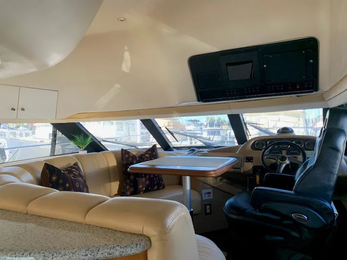  Yacht Photos Pics Interior of 2002 Carver 450 Voyager Pilothouse with leather seating and helm.