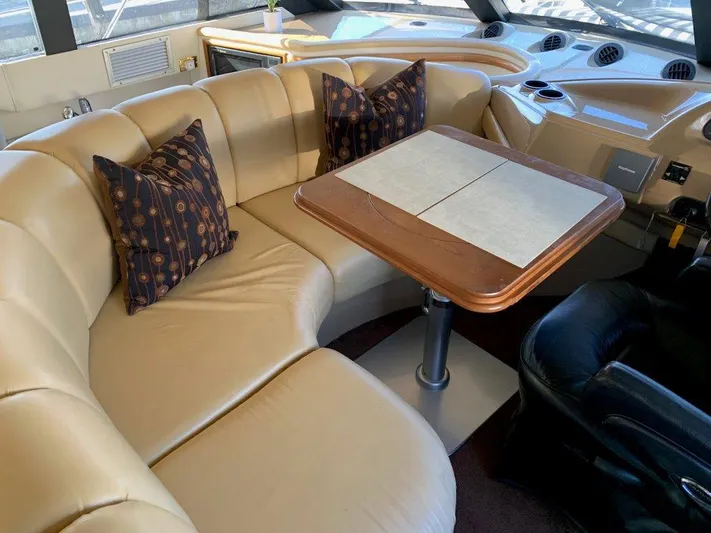  Yacht Photos Pics Luxurious interior of 2002 Carver 450 Voyager Pilothouse with leather seating and wooden table.