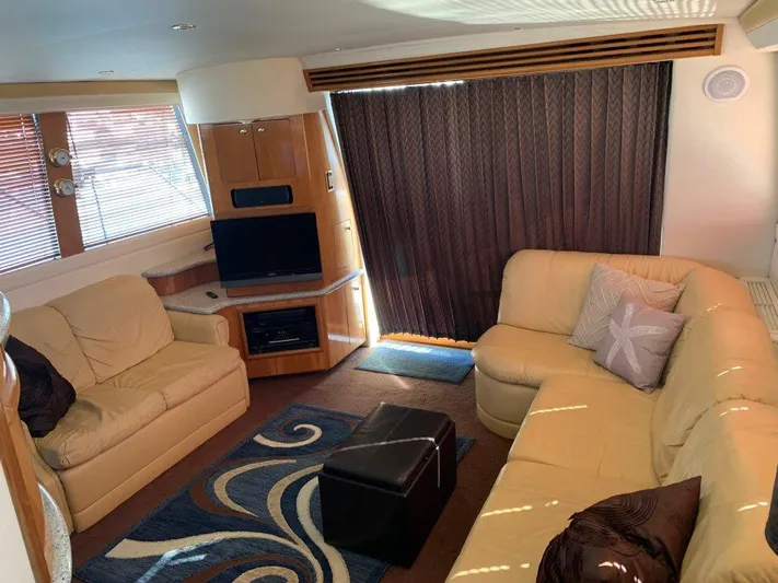  Yacht Photos Pics Luxurious interior of 2002 Carver 450 Voyager Pilothouse with beige seating and modern decor.