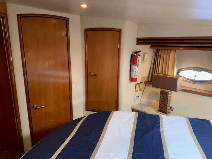 Yacht Photos Pics Interior of 2002 Carver 450 Voyager Pilothouse with wood doors and striped bedding.