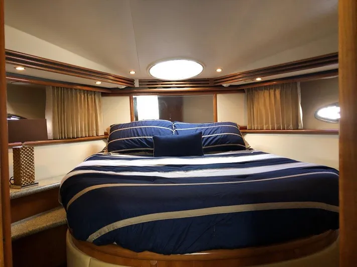  Yacht Photos Pics Luxurious bedroom in 2002 Carver 450 Voyager Pilothouse yacht with striped bedding.