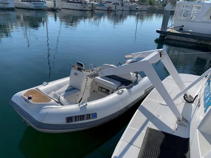  Yacht Photos Pics Small inflatable boat docked beside a Carver 450 Voyager Pilothouse, 2002 model.