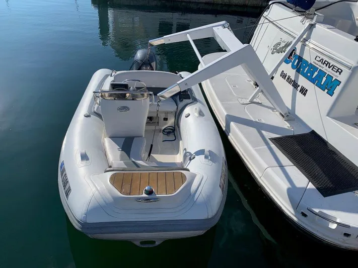  Yacht Photos Pics 2002 Carver 450 Voyager Pilothouse docked with inflatable dinghy.