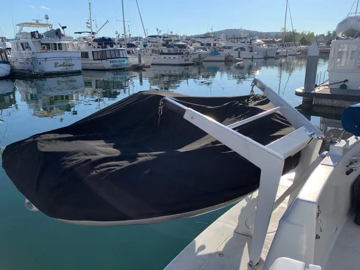  Yacht Photos Pics 2002 Carver 450 Voyager Pilothouse docked in a marina, covered boat on deck.