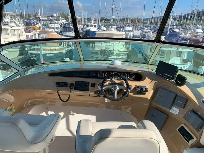  Yacht Photos Pics 2002 Carver 450 Voyager Pilothouse helm with marina view.