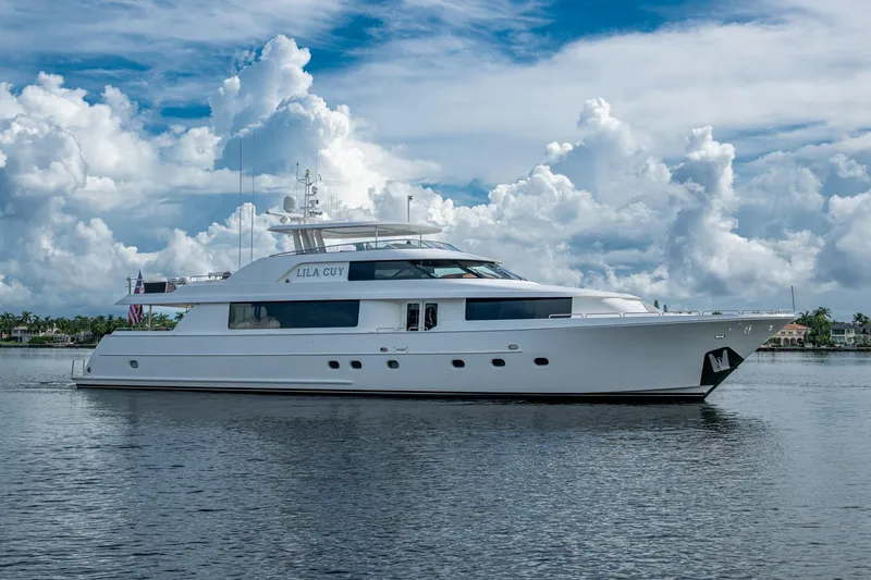 Lila Cuy Yacht Photos Pics Luxury 2006 Westport 112 yacht on calm water under a cloudy sky.