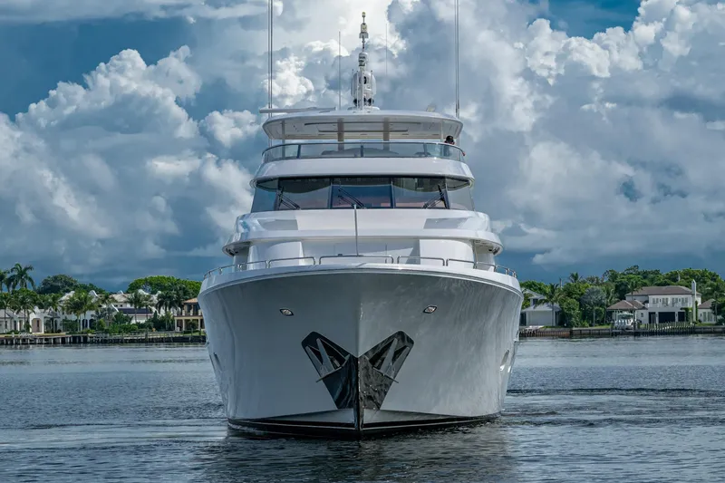 Lila Cuy Yacht Photos Pics Luxurious 2006 Westport 112 yacht on calm waters under cloudy sky.