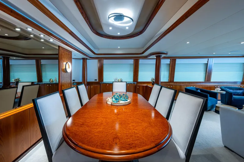 Lila Cuy Yacht Photos Pics Luxurious dining area on 2006 Westport 112 yacht with elegant wood table and chairs.