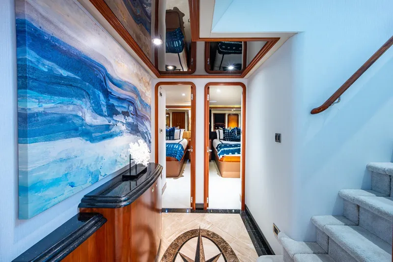 Lila Cuy Yacht Photos Pics Luxurious interior of 2006 Westport 112 yacht with modern decor and elegant staircase.