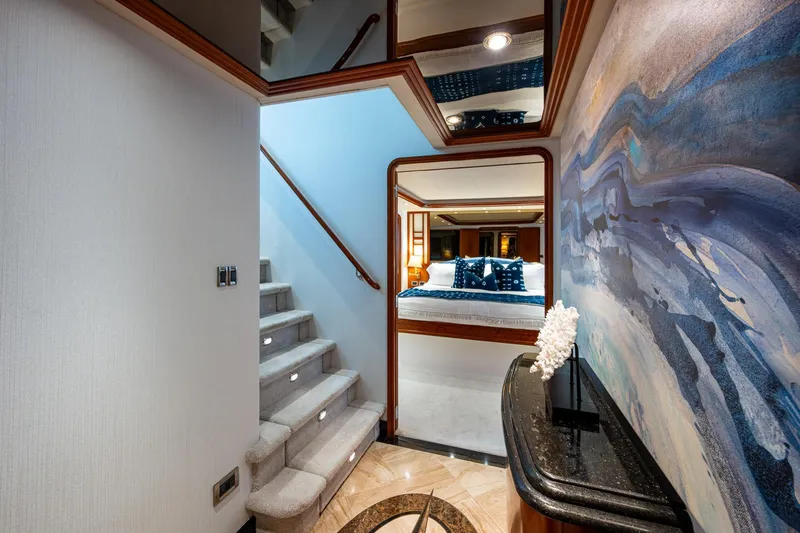 Lila Cuy Yacht Photos Pics Luxurious interior of 2006 Westport 112 yacht with elegant staircase and bedroom view.