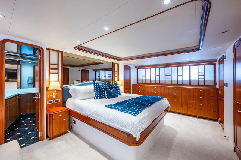 Lila Cuy Yacht Photos Pics Luxurious bedroom interior on 2006 Westport 112 yacht, featuring elegant wood finishes and modern design.