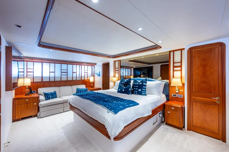 Lila Cuy Yacht Photos Pics Luxurious Westport 112 yacht bedroom, 2006 model, featuring elegant wood accents and plush bedding.