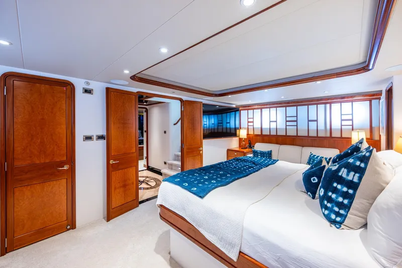 Lila Cuy Yacht Photos Pics Luxurious bedroom interior on 2006 Westport 112 yacht, featuring elegant wood finishes and modern decor.