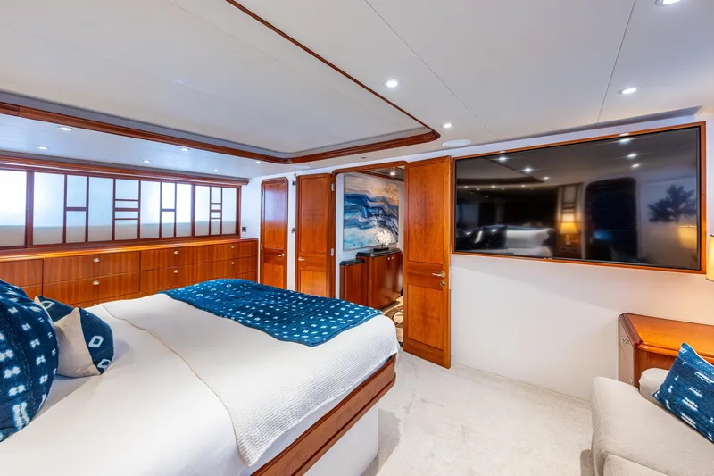 Lila Cuy Yacht Photos Pics Luxurious bedroom interior on 2006 Westport 112 yacht, featuring elegant wood finishes and modern amenities.