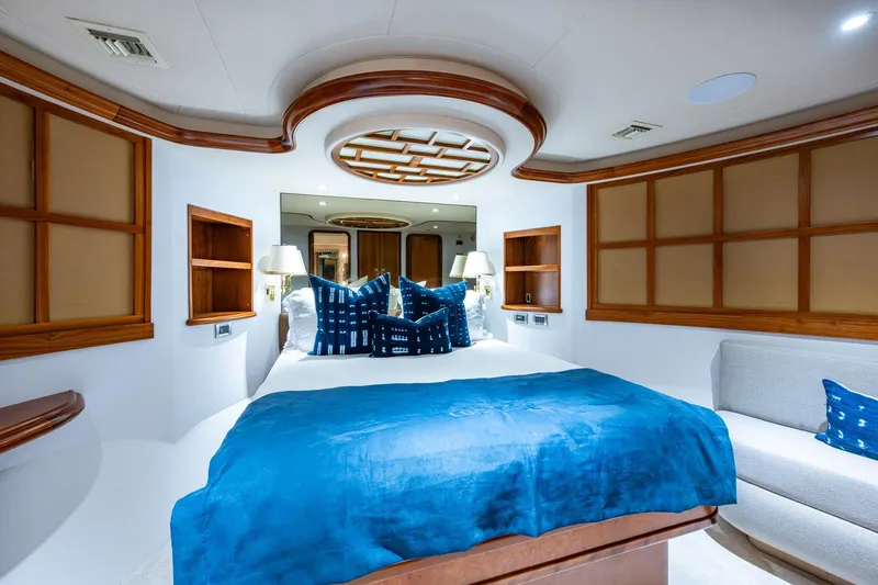 Lila Cuy Yacht Photos Pics Luxurious 2006 Westport 112 yacht bedroom with blue bedding and elegant wood accents.
