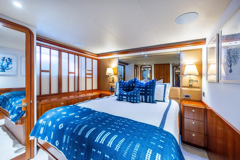 Lila Cuy Yacht Photos Pics Luxurious 2006 Westport 112 yacht bedroom with elegant blue decor and wooden accents.