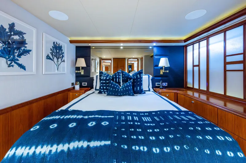 Lila Cuy Yacht Photos Pics Luxurious 2006 Westport 112 yacht bedroom with blue decor and elegant wood accents.