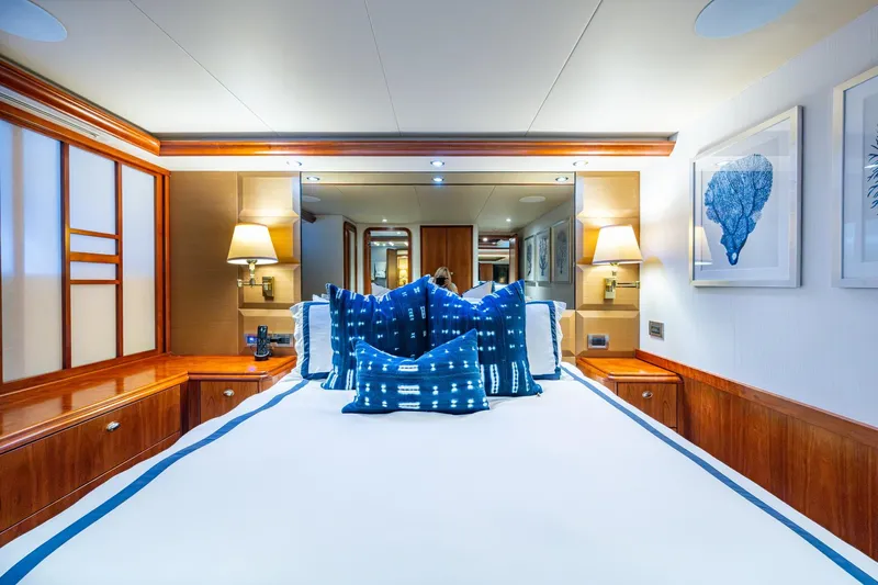 Lila Cuy Yacht Photos Pics Luxurious 2006 Westport 112 yacht bedroom with elegant decor and blue accents.