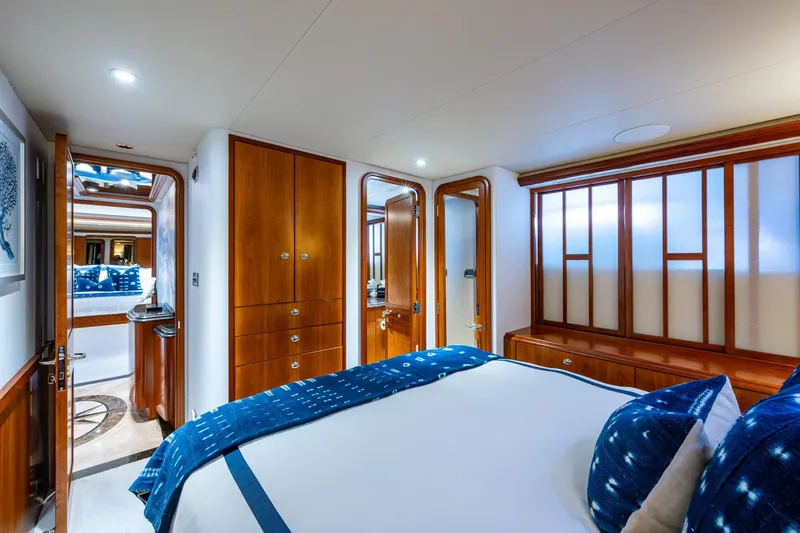 Lila Cuy Yacht Photos Pics Luxurious bedroom interior on 2006 Westport 112 yacht, featuring elegant wood finishes and plush bedding.
