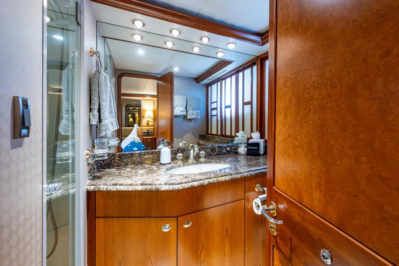 Lila Cuy Yacht Photos Pics Luxurious bathroom interior on 2006 Westport 112 yacht with marble countertop and wooden cabinetry.