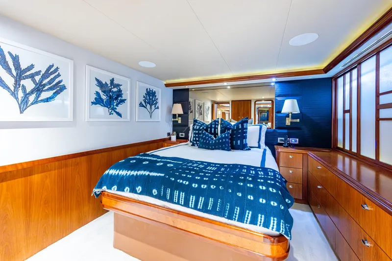 Lila Cuy Yacht Photos Pics Luxurious bedroom interior on 2006 Westport 112 yacht, featuring elegant decor and blue accents.