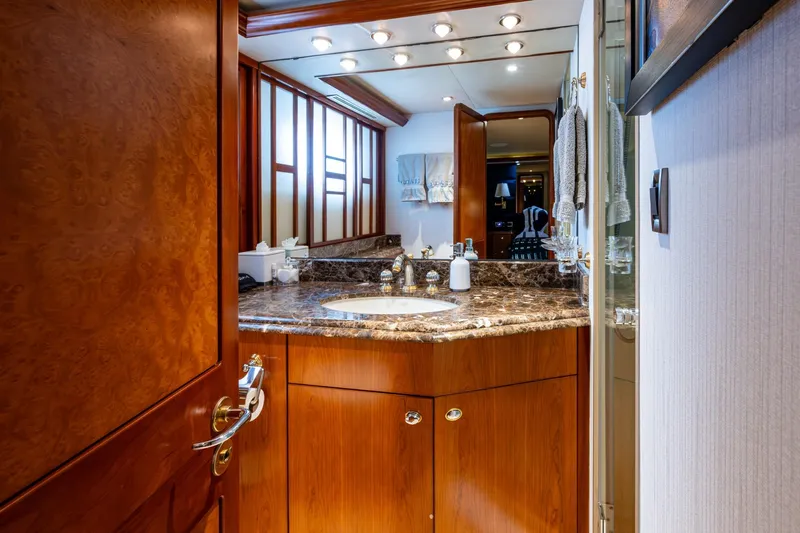 Lila Cuy Yacht Photos Pics Luxurious bathroom interior on 2006 Westport 112 yacht, featuring marble countertop and elegant wood finishes.
