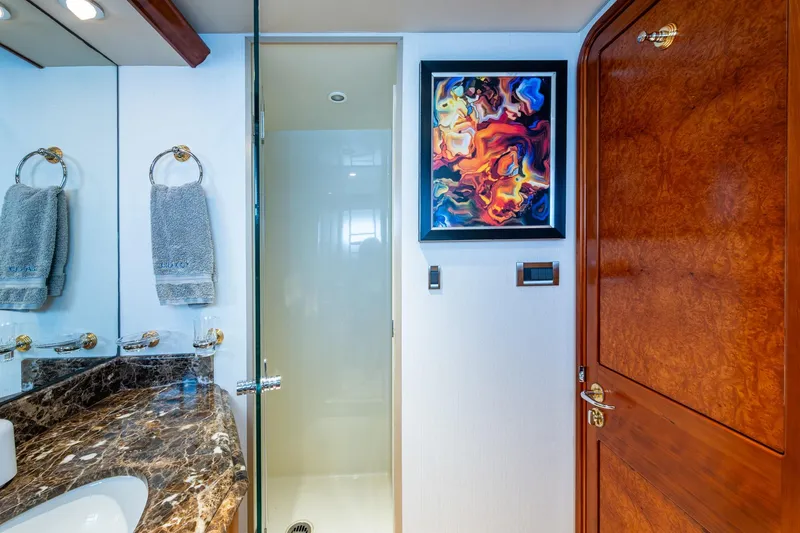 Lila Cuy Yacht Photos Pics Luxurious yacht bathroom with marble countertop, abstract art, and wooden door, Westport 112, 2006.