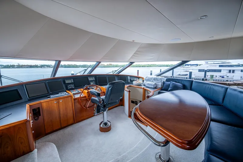 Lila Cuy Yacht Photos Pics Luxurious 2006 Westport 112 yacht interior with helm, leather seating, and panoramic windows.