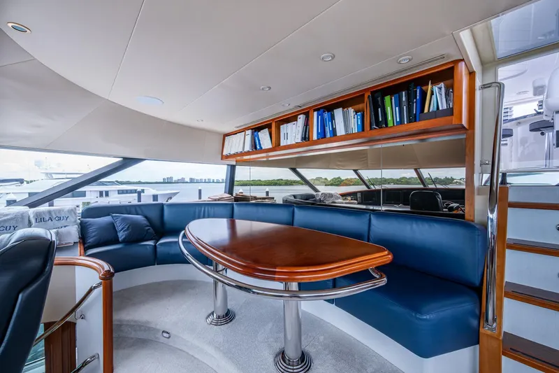 Lila Cuy Yacht Photos Pics Luxurious interior of 2006 Westport 112 yacht with elegant seating and wooden table.