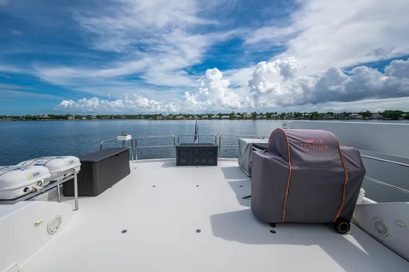 Lila Cuy Yacht Photos Pics Deck view of 2006 Westport 112 yacht with covered grill and scenic waterfront.