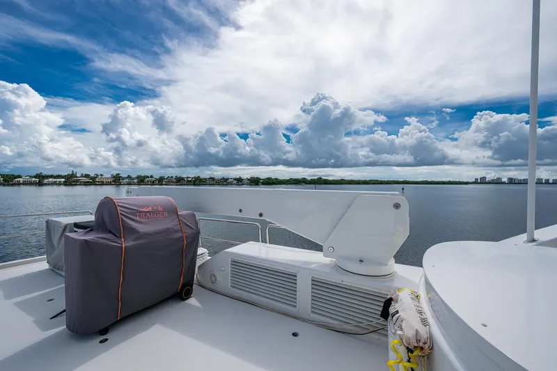 Lila Cuy Yacht Photos Pics Luxury yacht deck view on 2006 Westport 112, featuring a covered grill and scenic waterfront.