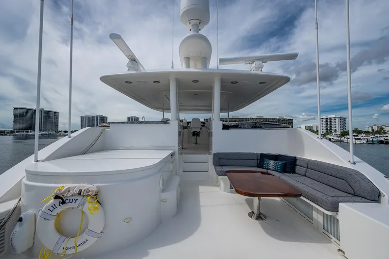 Lila Cuy Yacht Photos Pics Luxurious 2006 Westport 112 yacht deck with seating area and scenic waterfront view.