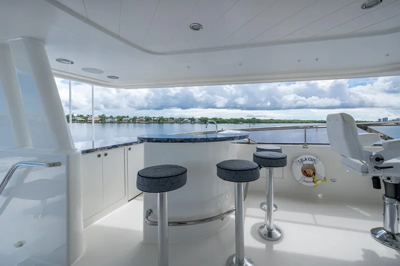 Lila Cuy Yacht Photos Pics Luxurious 2006 Westport 112 yacht deck with bar stools and scenic water view.