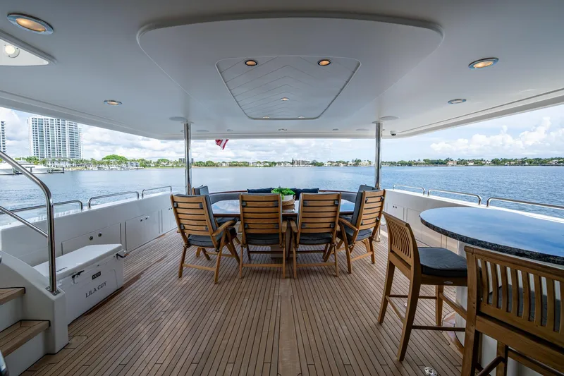 Lila Cuy Yacht Photos Pics Luxurious 2006 Westport 112 yacht deck with elegant seating and scenic waterfront view.