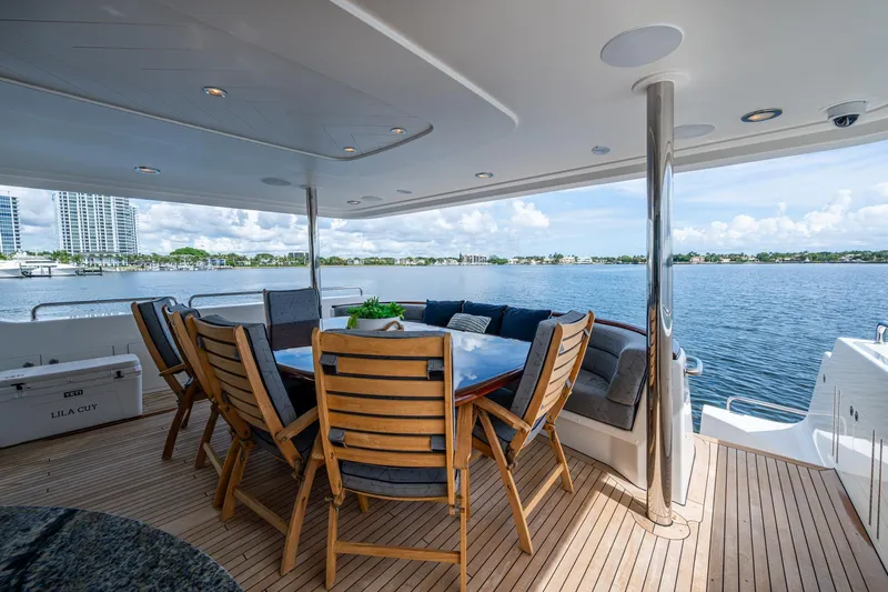 Lila Cuy Yacht Photos Pics Luxurious 2006 Westport 112 yacht deck with dining area overlooking serene waterfront.