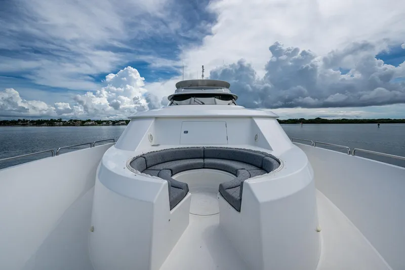 Lila Cuy Yacht Photos Pics Luxurious 2006 Westport 112 yacht with spacious deck seating under cloudy sky.
