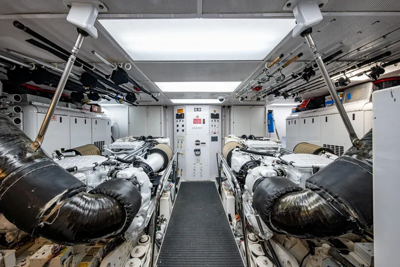 Lila Cuy Yacht Photos Pics Engine room of 2006 Westport 112 yacht, featuring dual engines and organized equipment storage.