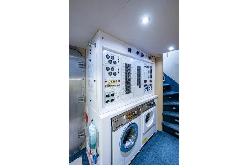 Lila Cuy Yacht Photos Pics Laundry and control room aboard 2006 Westport 112 yacht, featuring washer, dryer, and control panel.