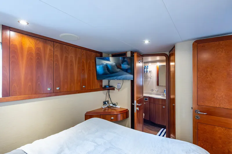 Lila Cuy Yacht Photos Pics Luxurious 2006 Westport 112 yacht bedroom with wood cabinetry and ensuite bathroom.