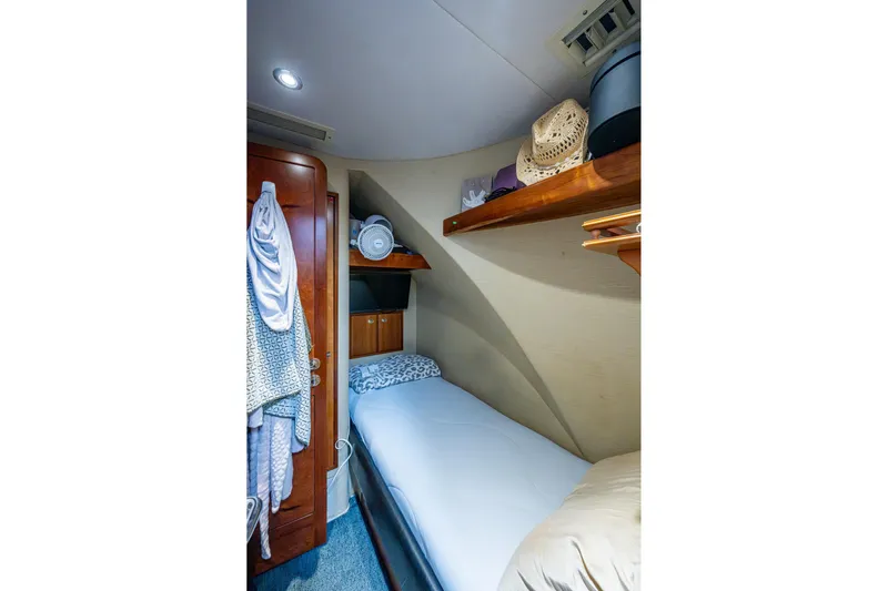 Lila Cuy Yacht Photos Pics Cozy cabin interior of 2006 Westport 112 yacht with single bed and wooden storage.