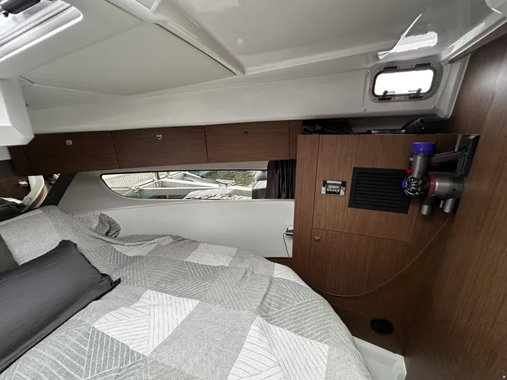  Yacht Photos Pics Interior cabin of 2019 Jeanneau Merry Fisher 1095 FLY with bed and wooden cabinetry.