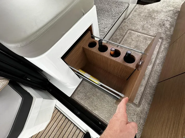  Yacht Photos Pics Pull-out storage drawer with bottle holders on a 2019 Jeanneau Merry Fisher 1095 FLY boat.