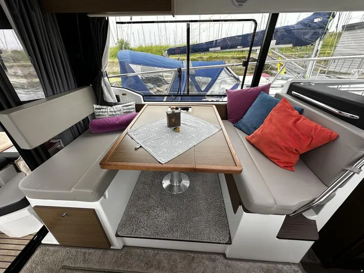  Yacht Photos Pics Interior of 2019 Jeanneau Merry Fisher 1095 FLY with cozy seating and colorful cushions.