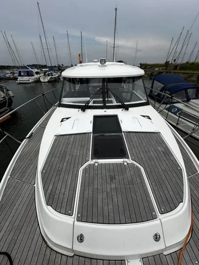  Yacht Photos Pics 2019 Jeanneau Merry Fisher 1095 FLY boat docked in marina, showcasing sleek design and spacious deck.
