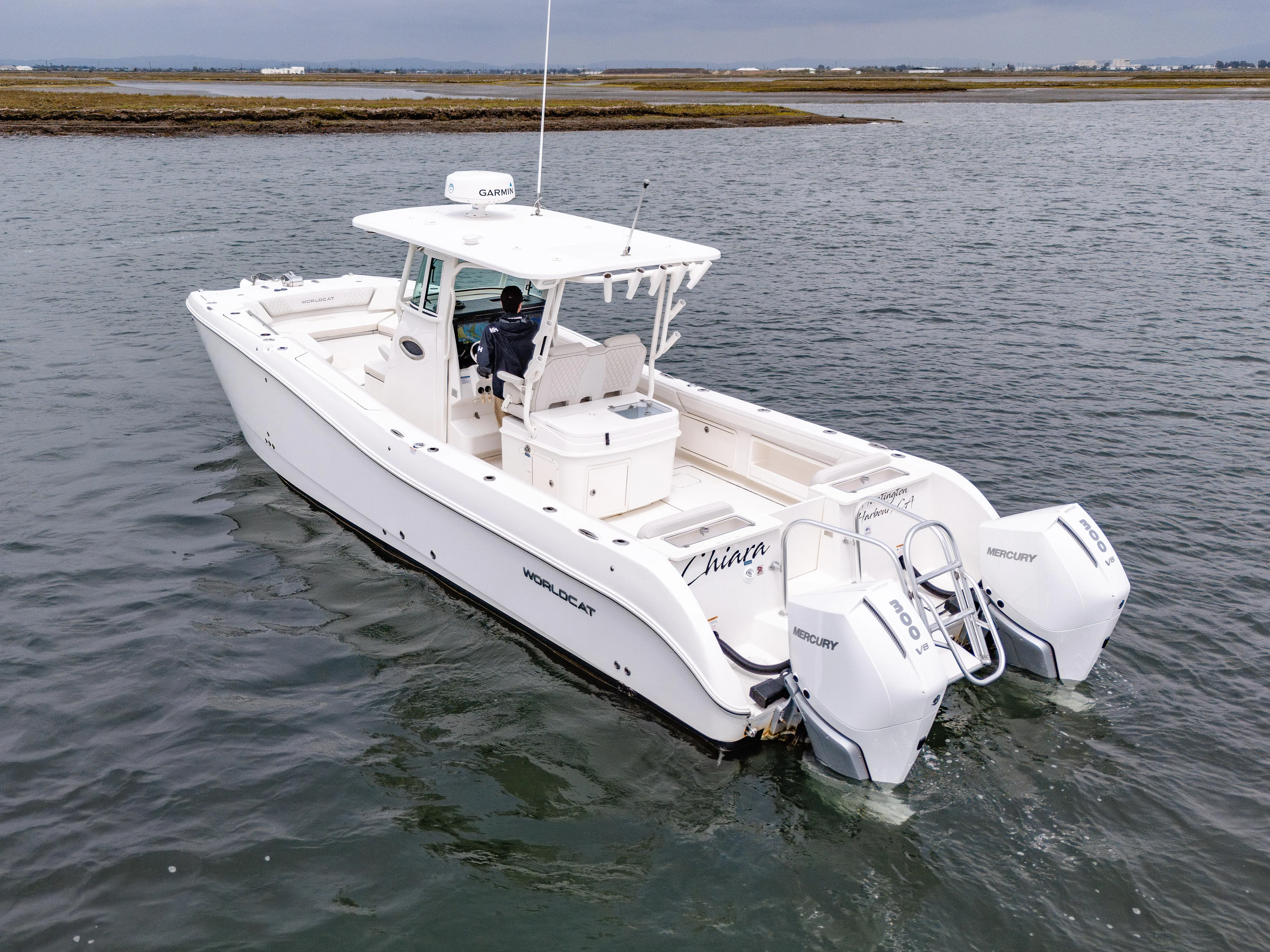  Yacht Photos Pics 2024 World Cat 325 CC boat on water, featuring dual outboard engines.