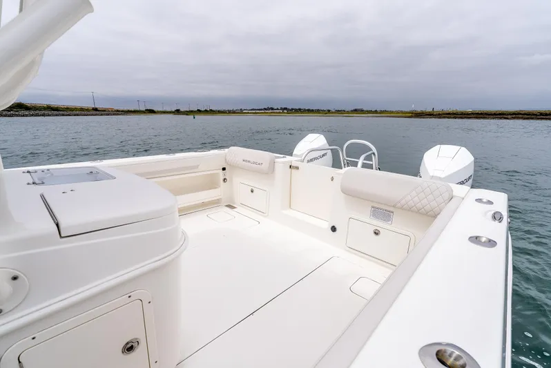  Yacht Photos Pics 2024 World Cat 325 CC boat interior with spacious seating and dual engines on calm water.