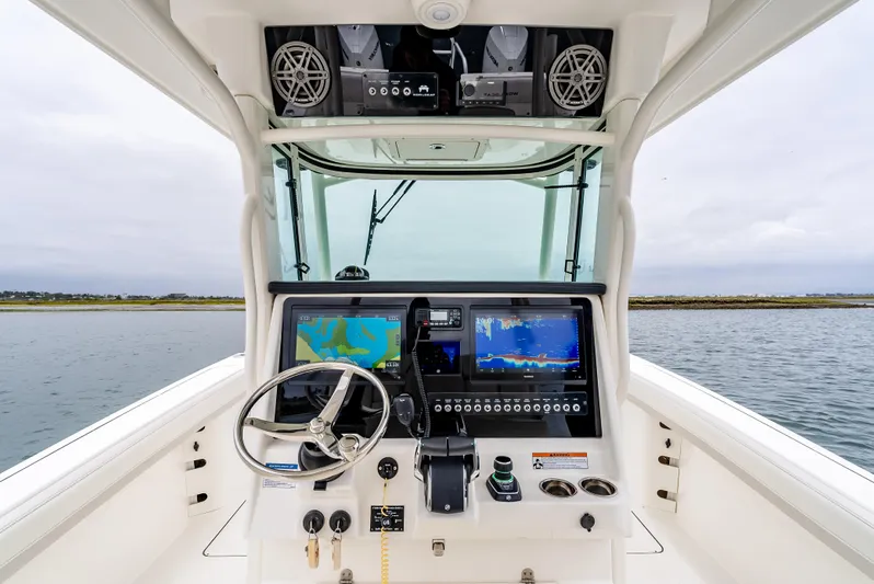  Yacht Photos Pics 2024 World Cat 325 CC helm with advanced navigation displays and controls on open water.