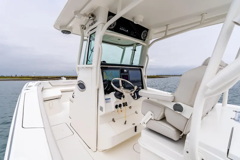  Yacht Photos Pics 2024 World Cat 325 CC boat cockpit with modern controls and comfortable seating on water.